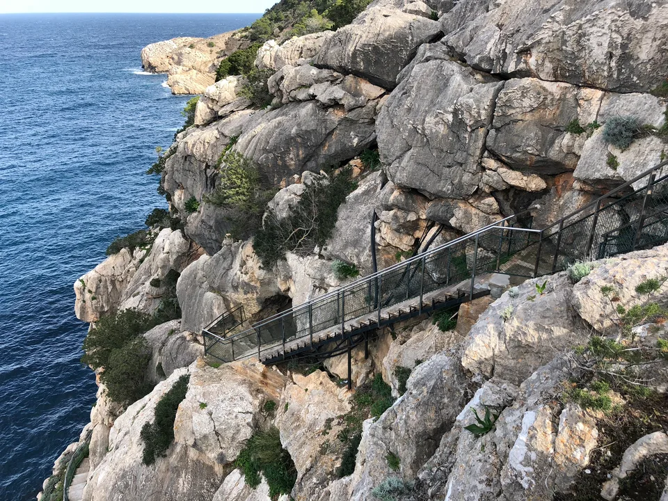 A rocky coastal path above the sea on Ibiza