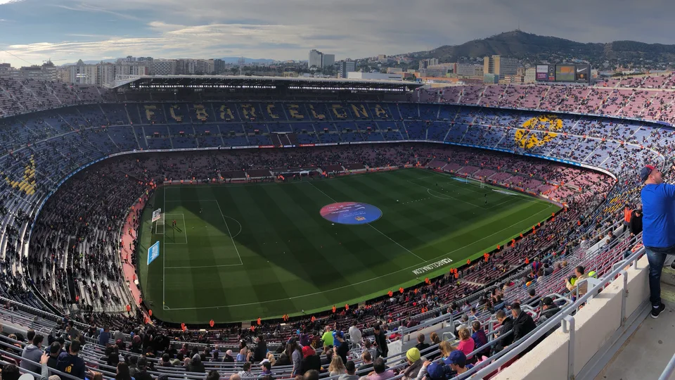 The Camp Nou pitch surrounded by sweeping stadium stands