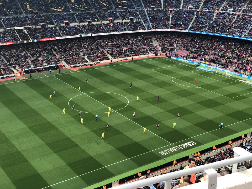 Football players on the Camp Nou pitch during a match