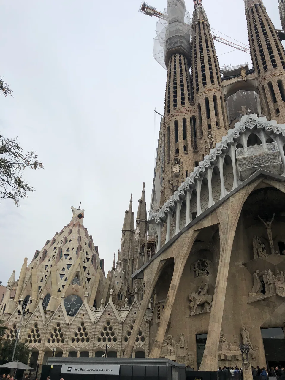 Carved stone details and towers of Sagrada Família seen from below