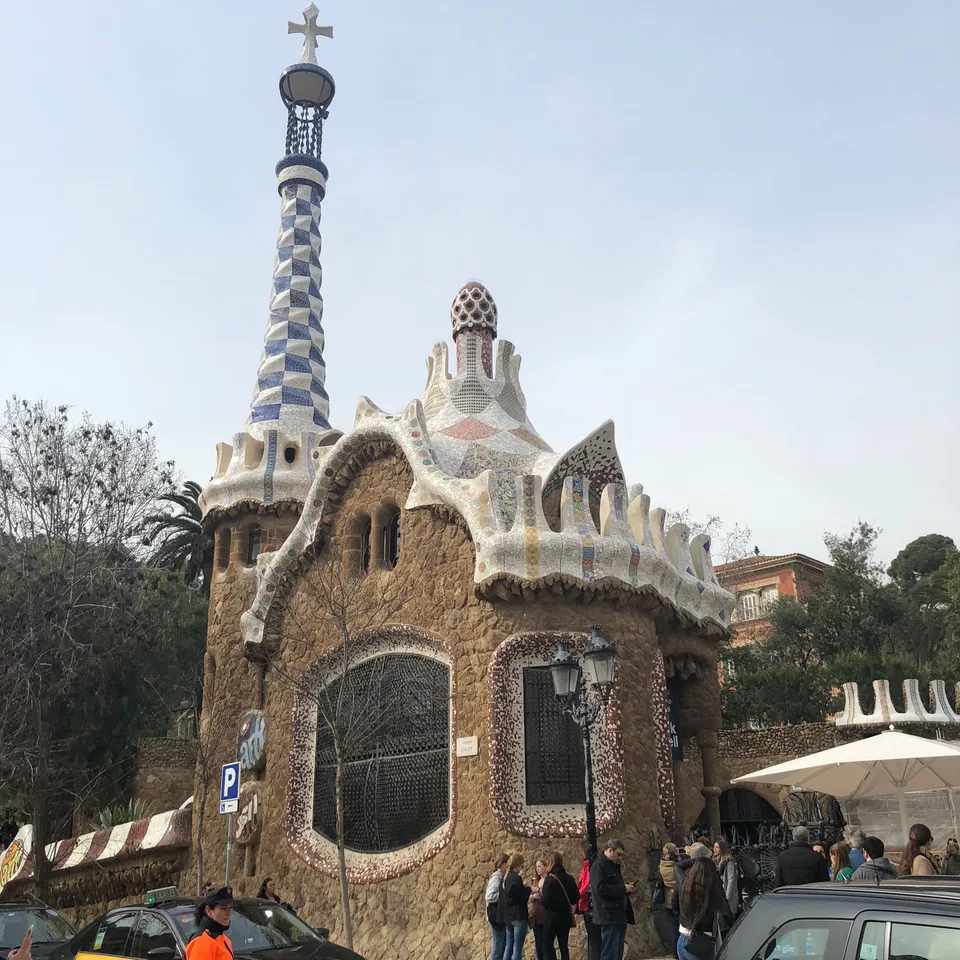 Mosaic-covered buildings and a spire at Park Güell