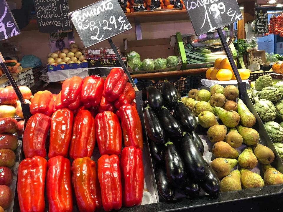 Red, green and yellow peppers at a produce stall