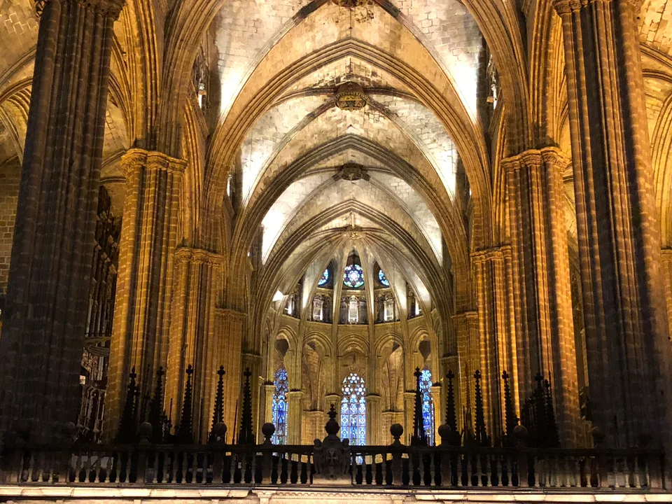 The vaulted nave and illuminated altar inside Barcelona Cathedral