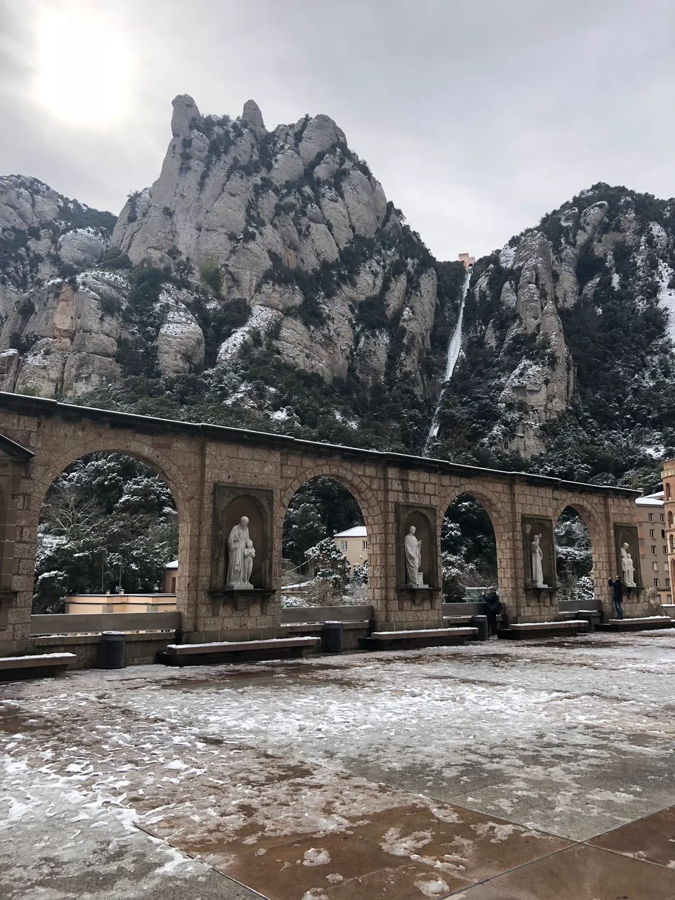 Serrated Montserrat rock peaks rising above monastery roofs