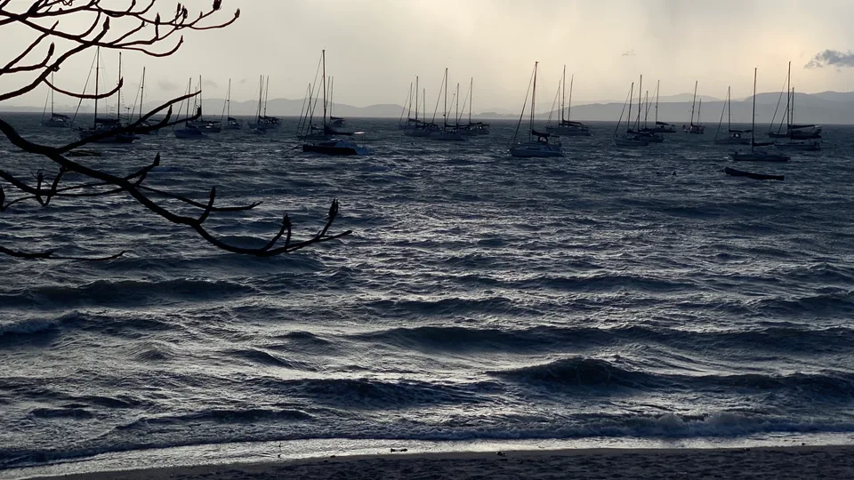 Moored sailboats on rippling water at dusk in Santo Antônio de Lisboa