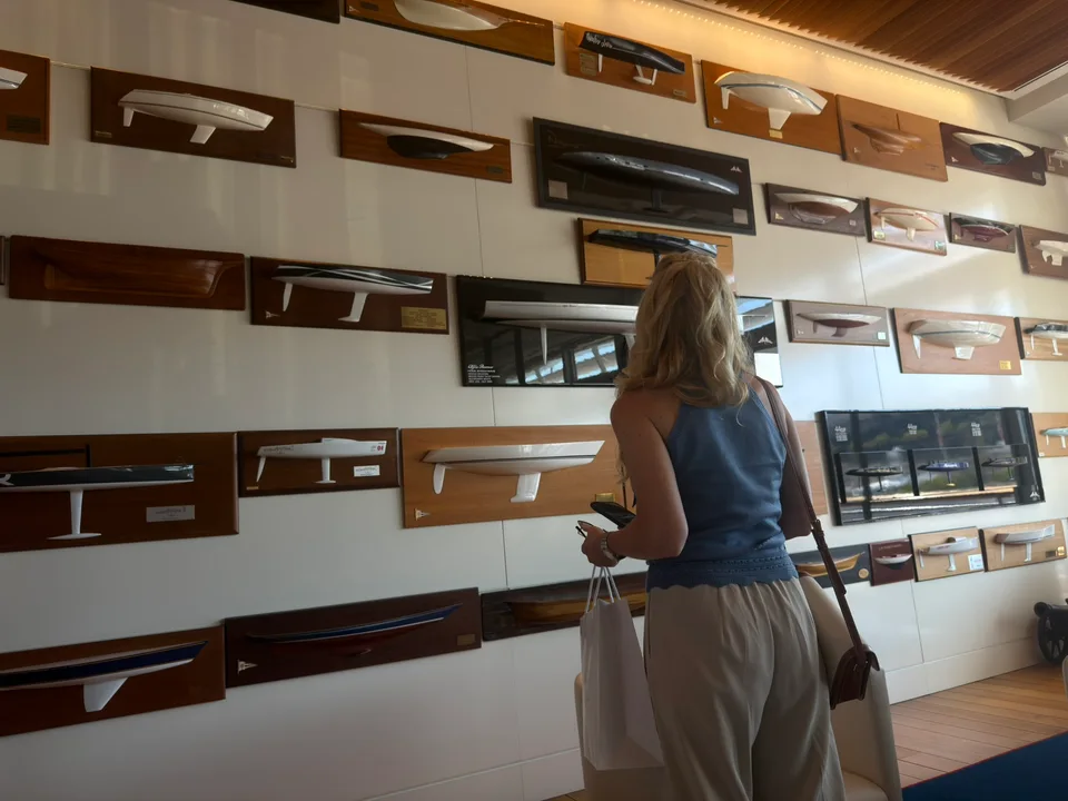 Model boats arranged on shelves inside the yacht club