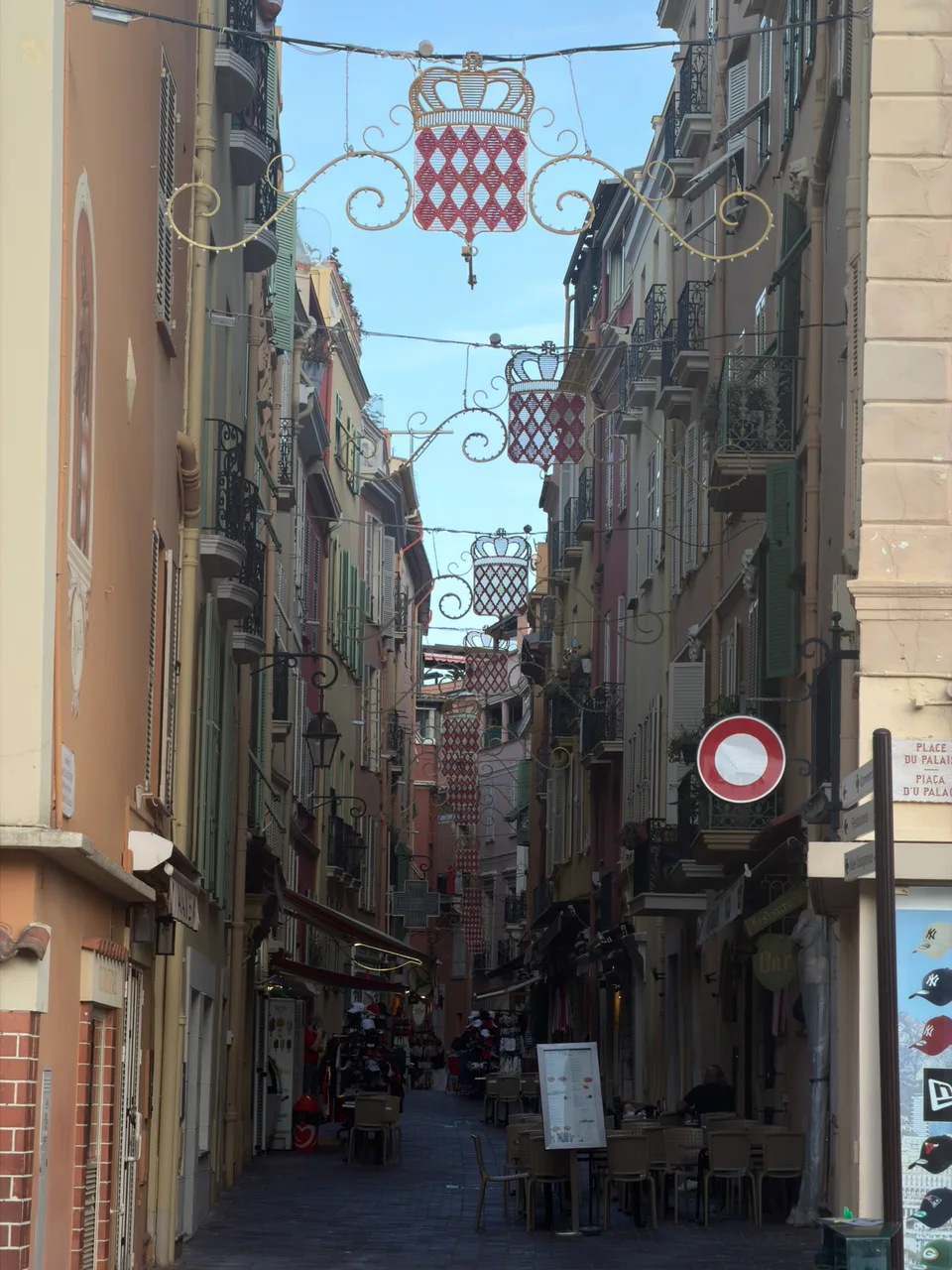 A narrow street in Monaco-Ville beneath a flag