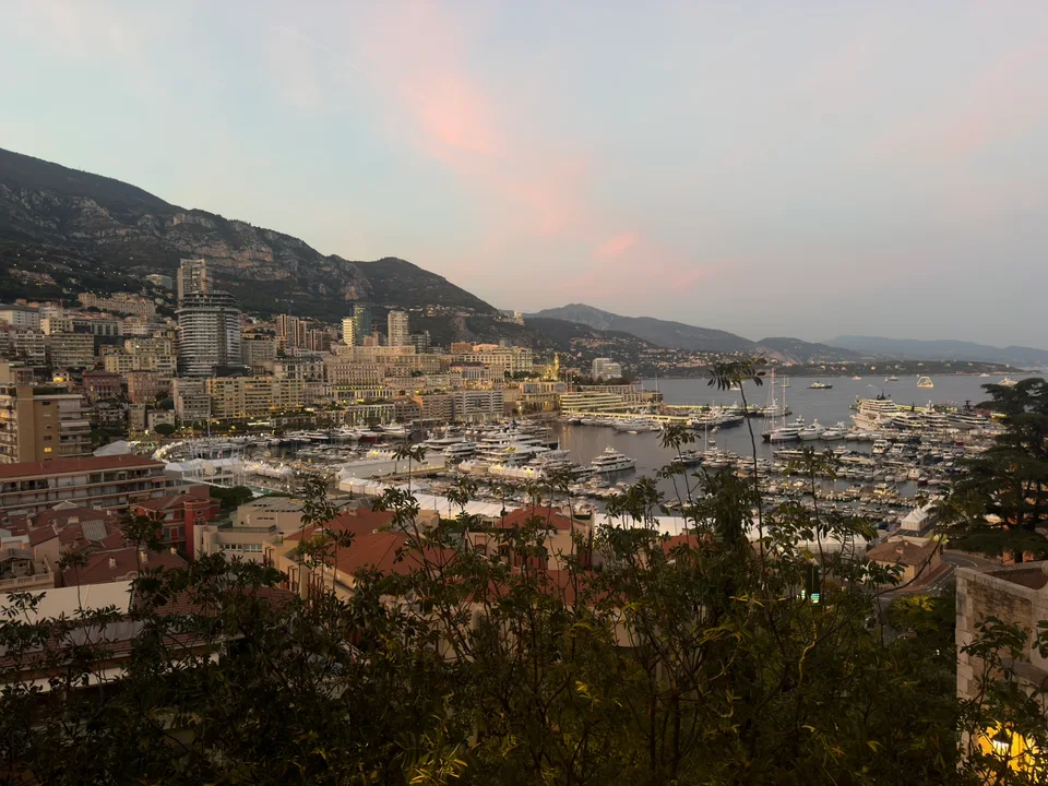 Monaco’s harbor and densely built hills at sunset