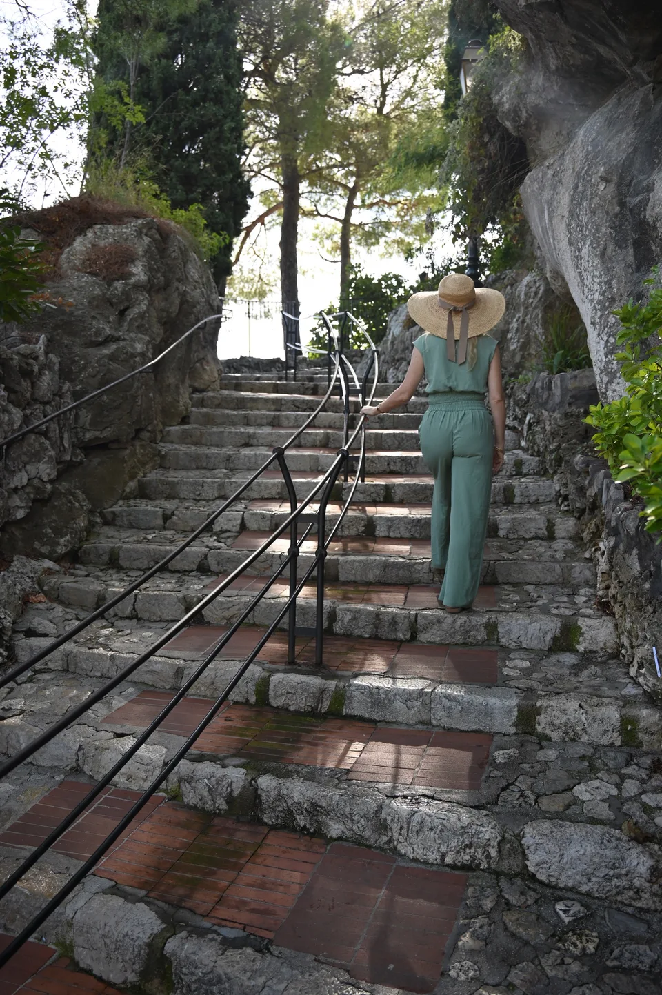 Stone steps climbing between walls and greenery in Èze