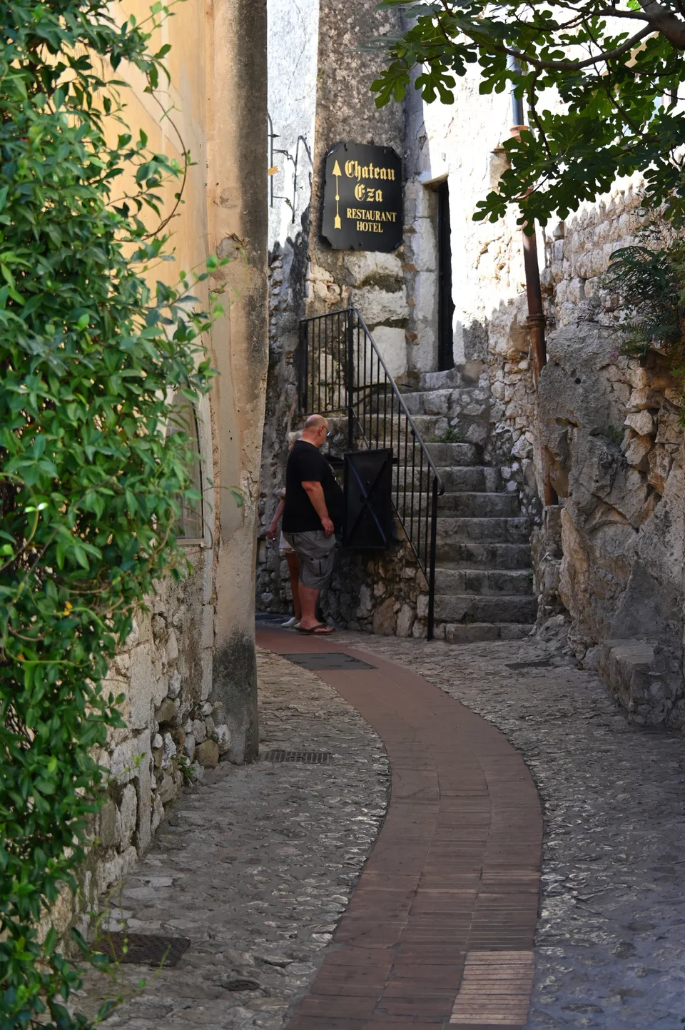 A narrow winding lane between stone houses in Èze