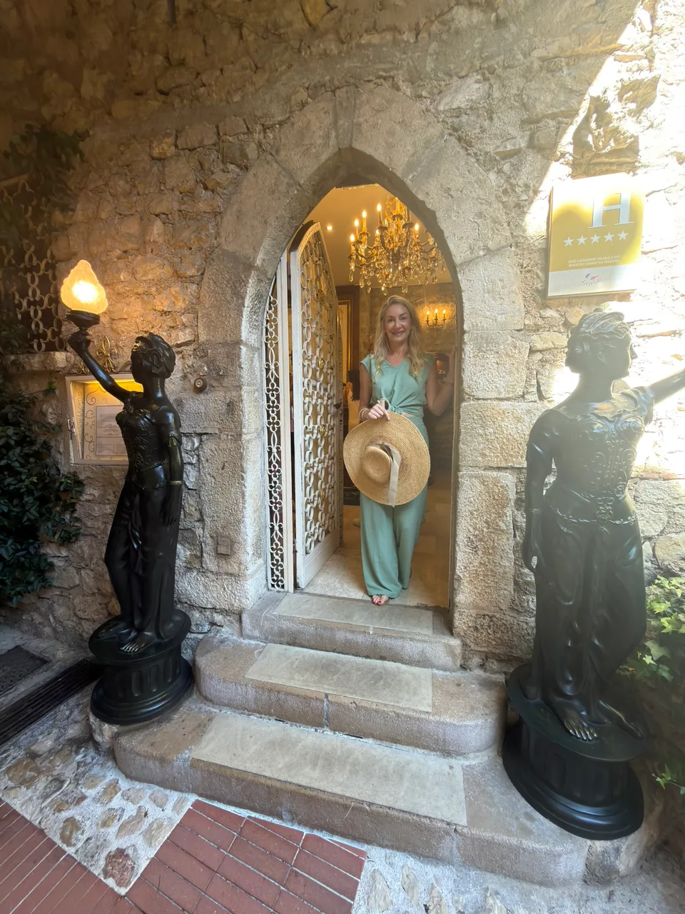 A vaulted stone entrance decorated with flowers in Èze
