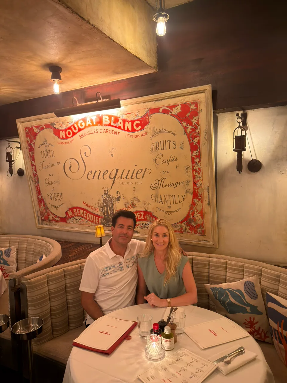 Alex and Kristin seated at a restaurant table in Saint-Tropez