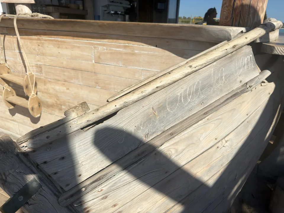 A weathered wooden boat resting near the shore