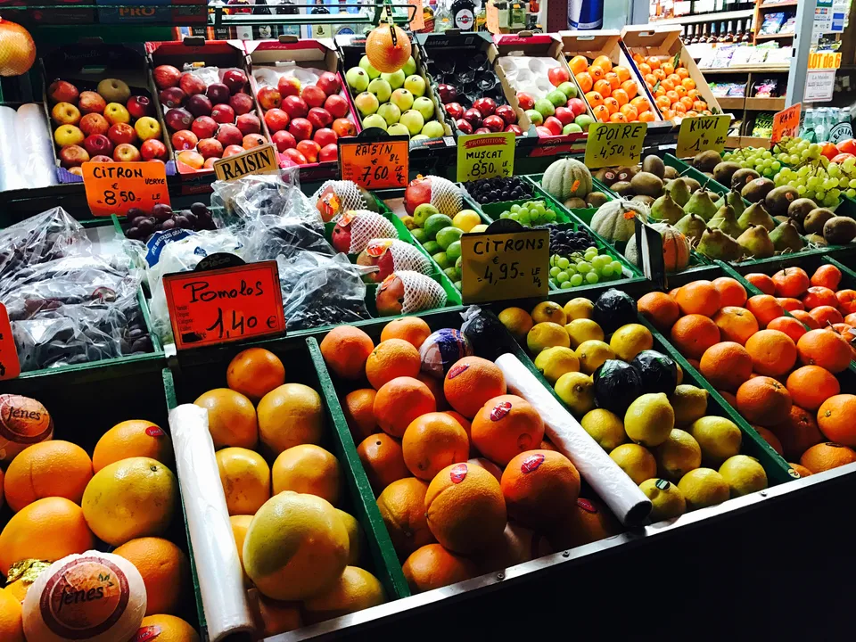 A Paris fruit display filled with colorful apples, oranges and other produce