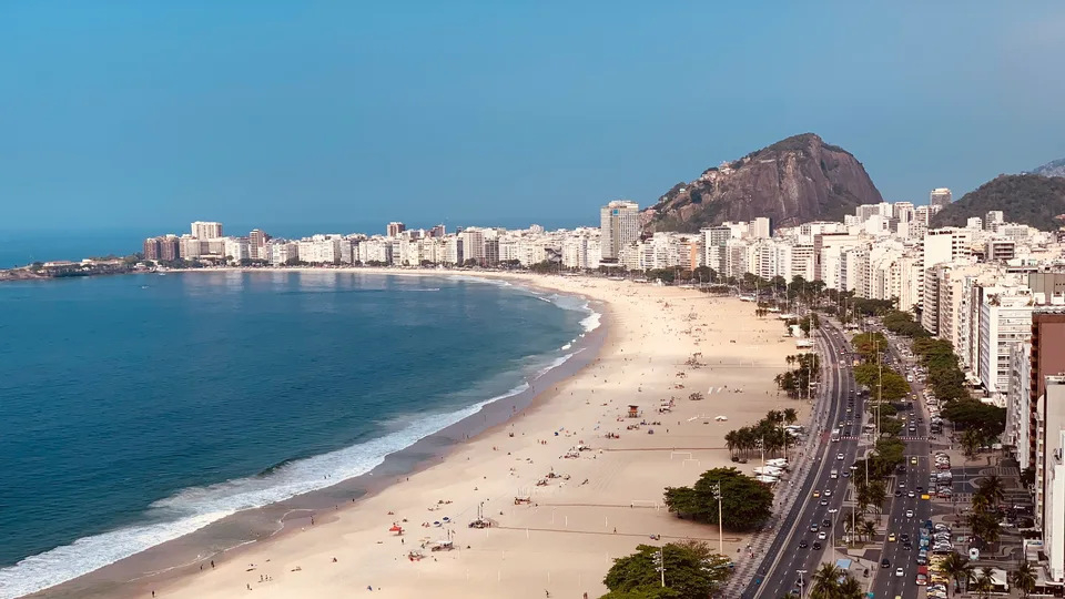 Copacabana’s curving beach and seafront buildings beneath a blue sky