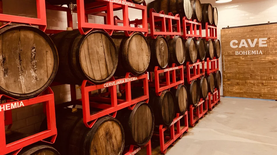 Wooden barrels in red racks at Cervejaria Bohemia