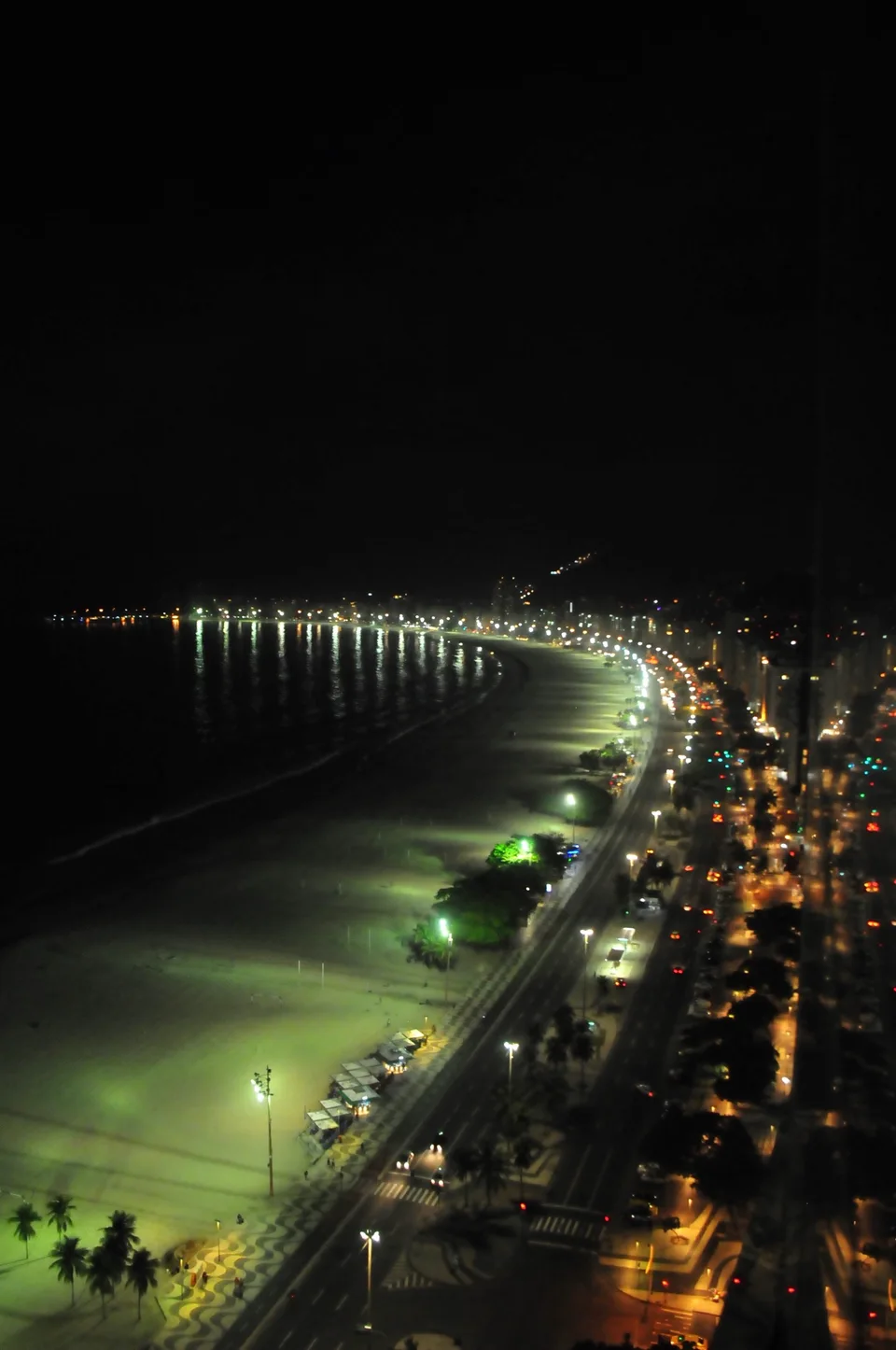 Copacabana’s illuminated beachfront curving into the night