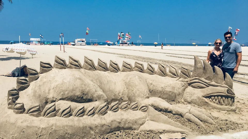 An elaborate reclining figure sculpted from sand on Copacabana beach