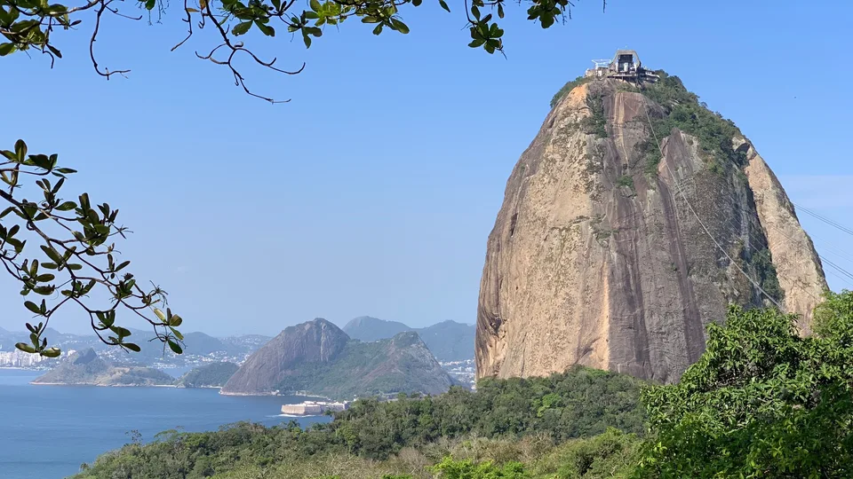 Sugarloaf mountain rising above trees and the bay