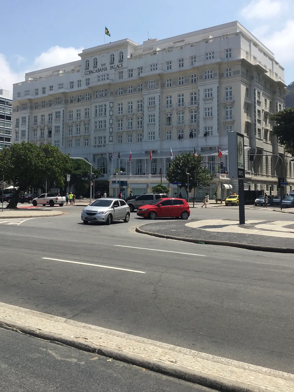 The white façade of the Copacabana Palace across the seafront road