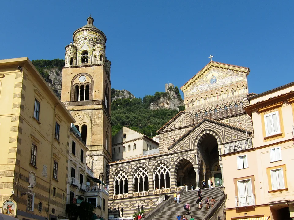 The ornate façade and broad staircase of Amalfi Cathedral above the town square